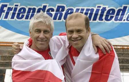 Kent funeral director Michael Owen, left, with Peter Crouch wrapped in the England flag. Picture courtesy FRIENDS REUNITED