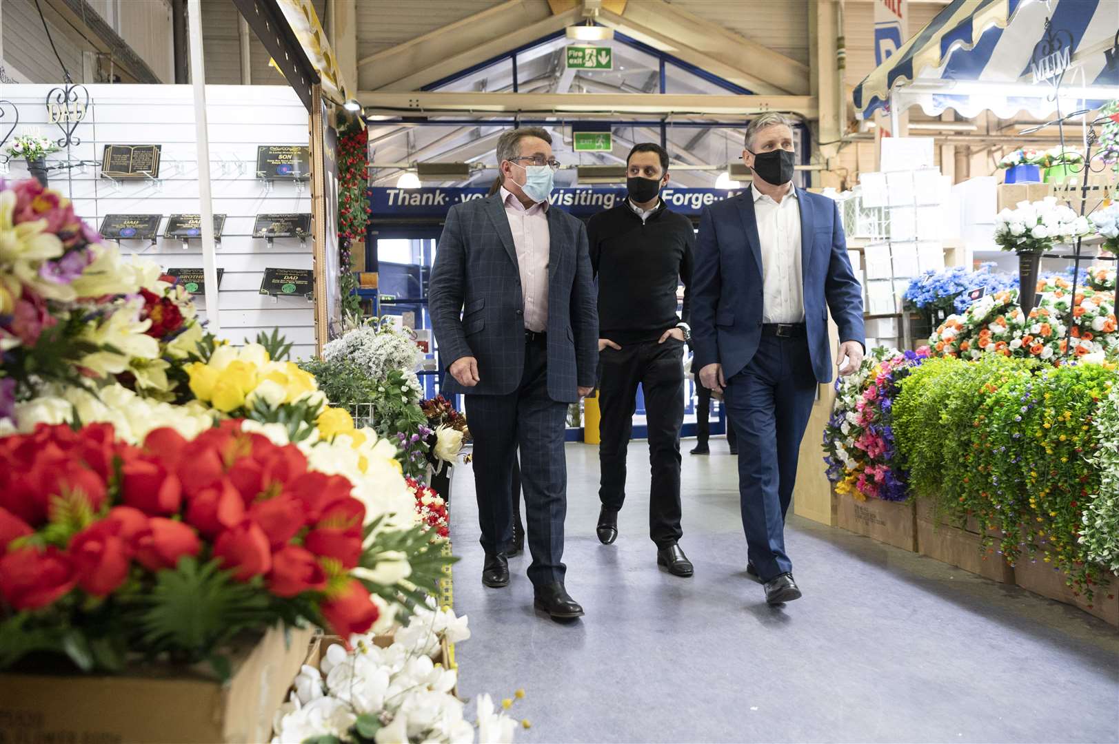 Sir Keir (right) and Anas Sarwar (centre) take a stroll through the Forge Market (John Linton/PA)