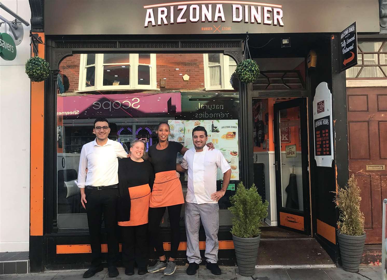 Abuzer Kartal, Charlotte Springate, and Heather Anderson with owner Muzo Tasdogan at Arizona Diner
