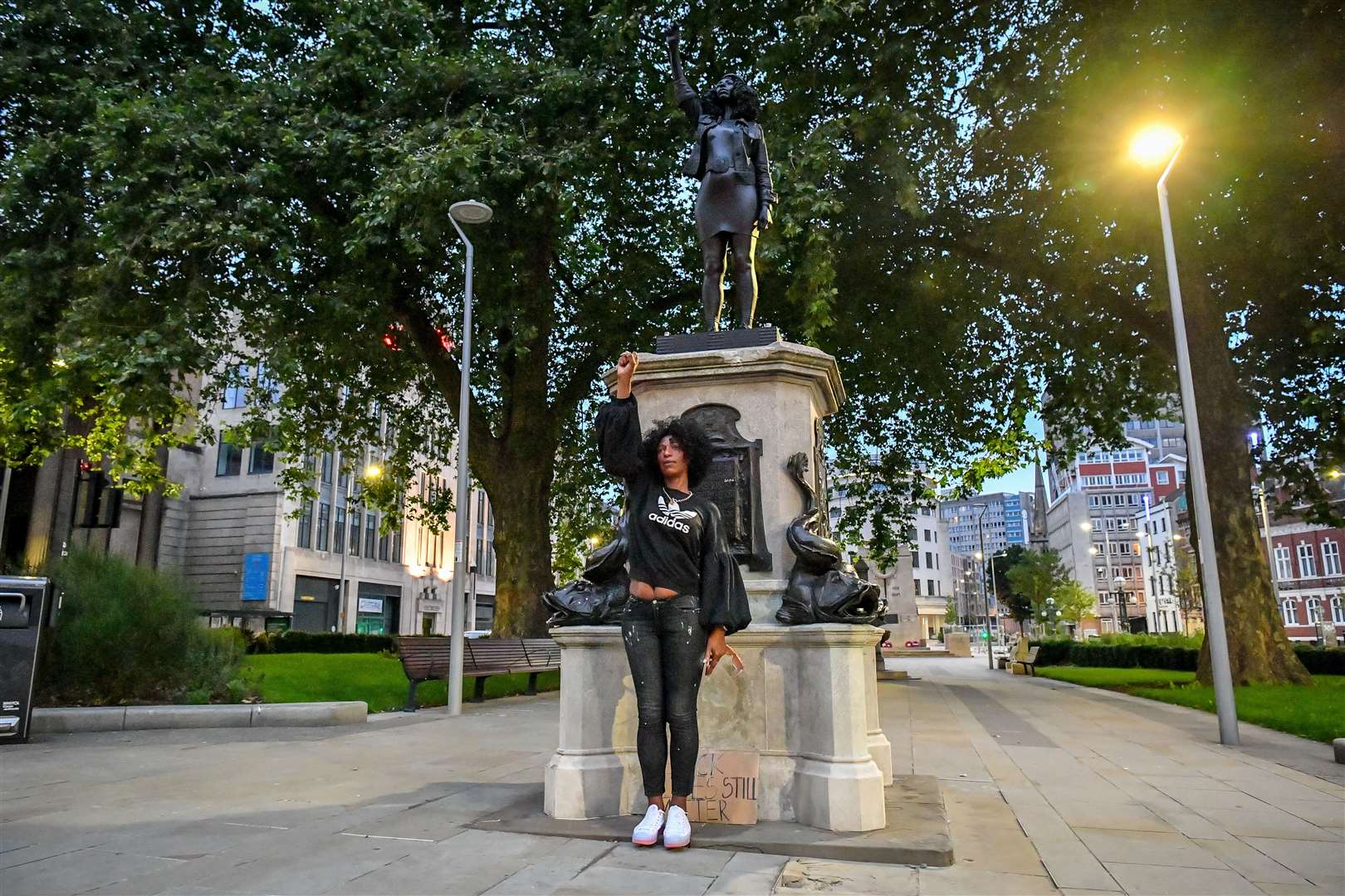 Jen Reid poses in front of her statue (Ben Birchall/PA)