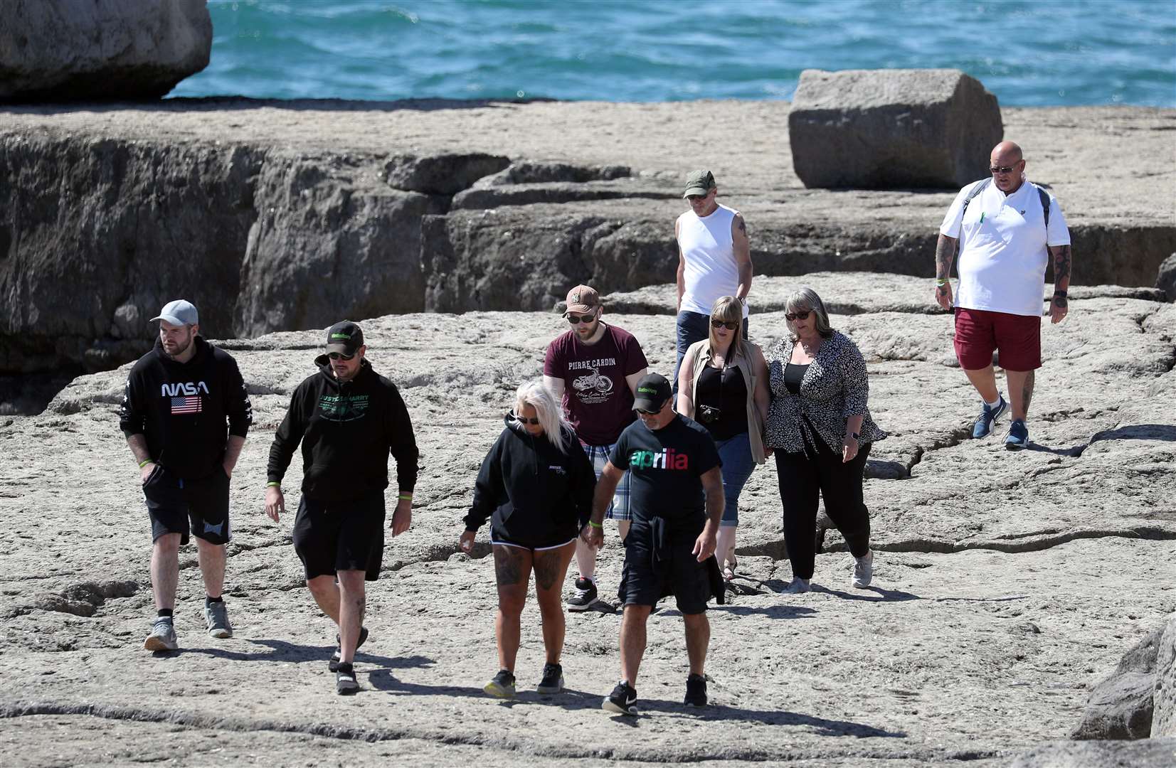 Charlotte Charles and and Tim Dunn gather with friends and family at Portland Bill to scatter their son’s ashes (Andrew Matthews/PA)