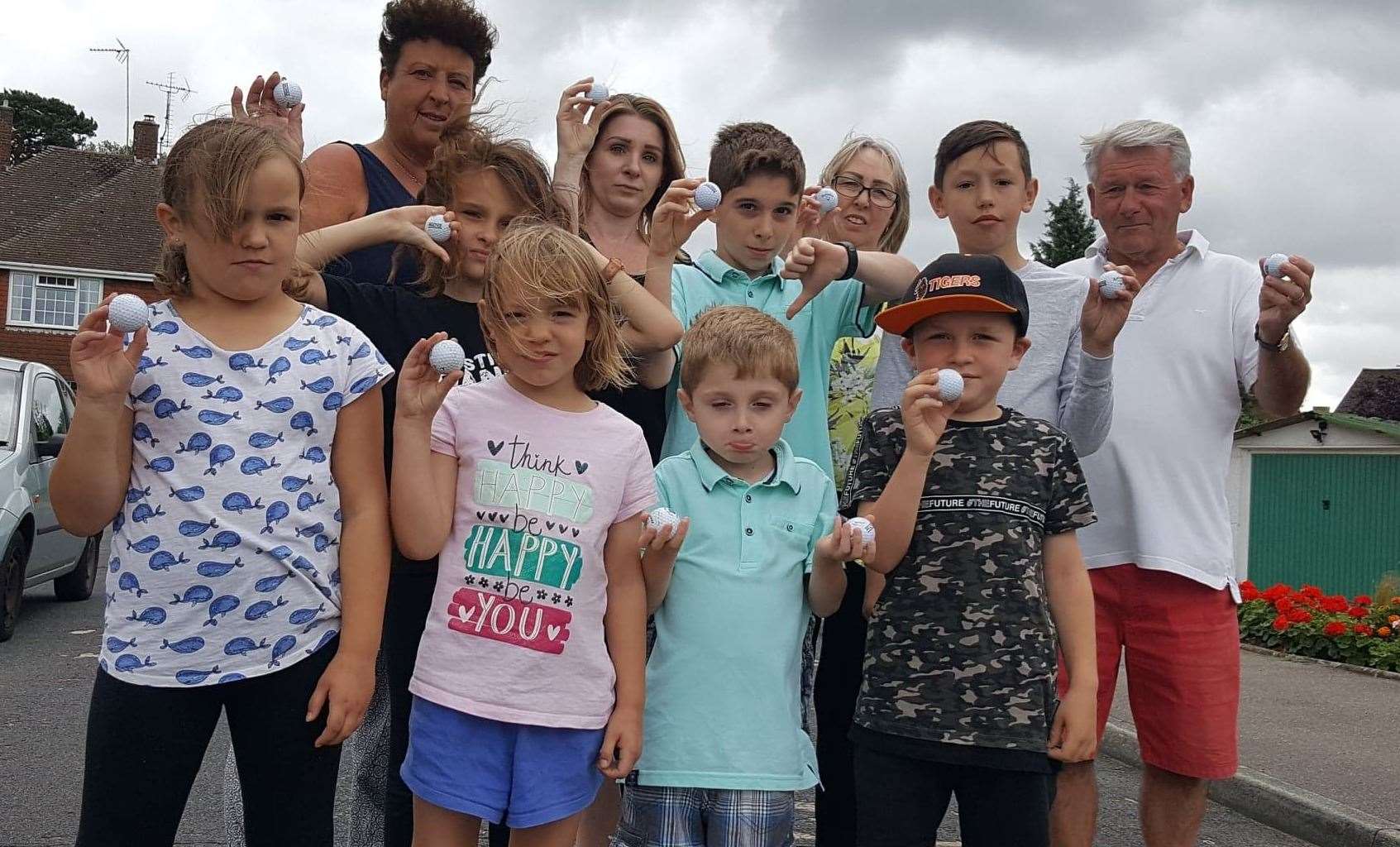 Residents are fed up with the flying golf balls; back row: Steff Plester, Lynsey Holmewood, Denise Austin and Malcolm Austin with children from the road