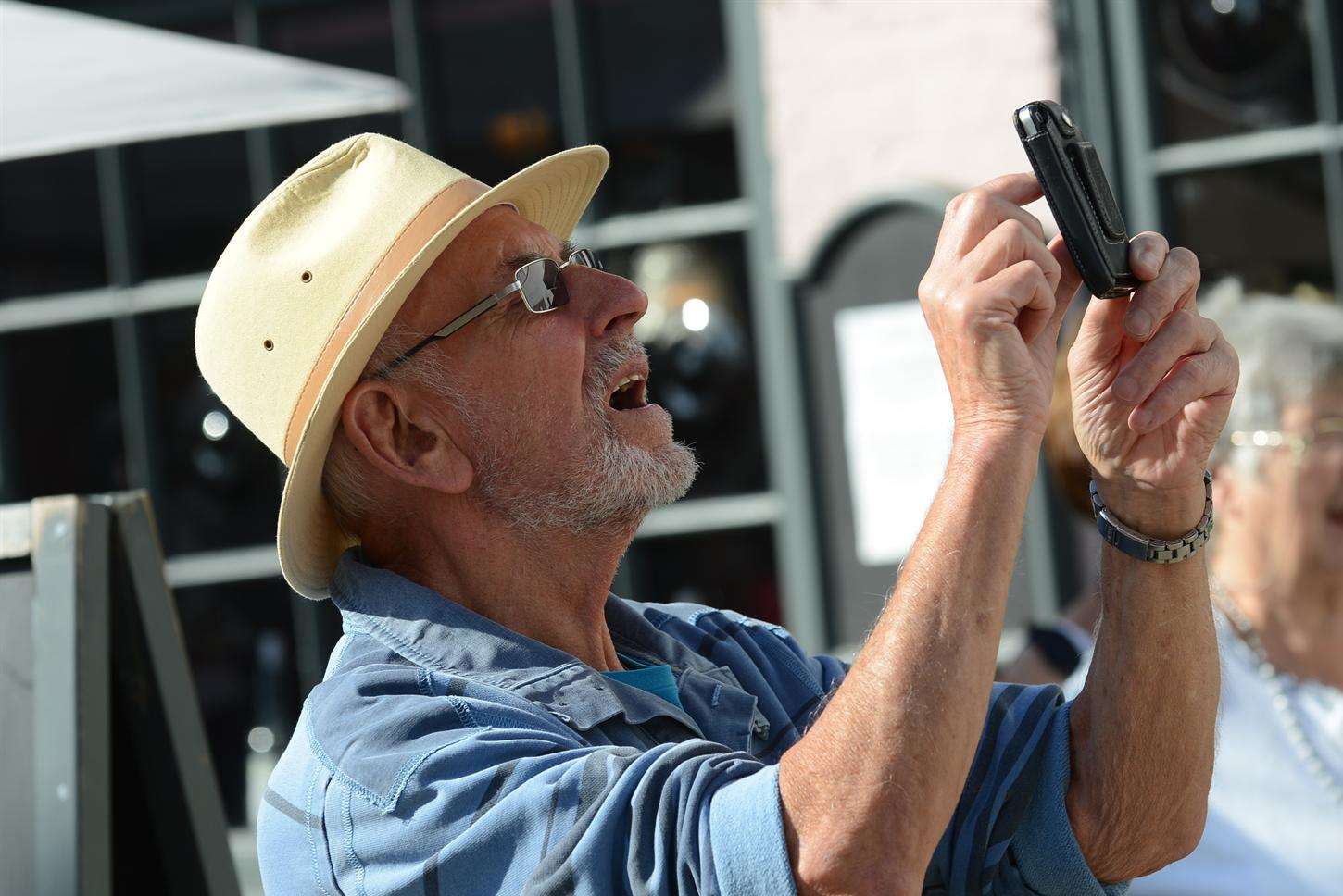 One for the album. A passerby photographs the sea shanty flashmob at Tenterden town hall.