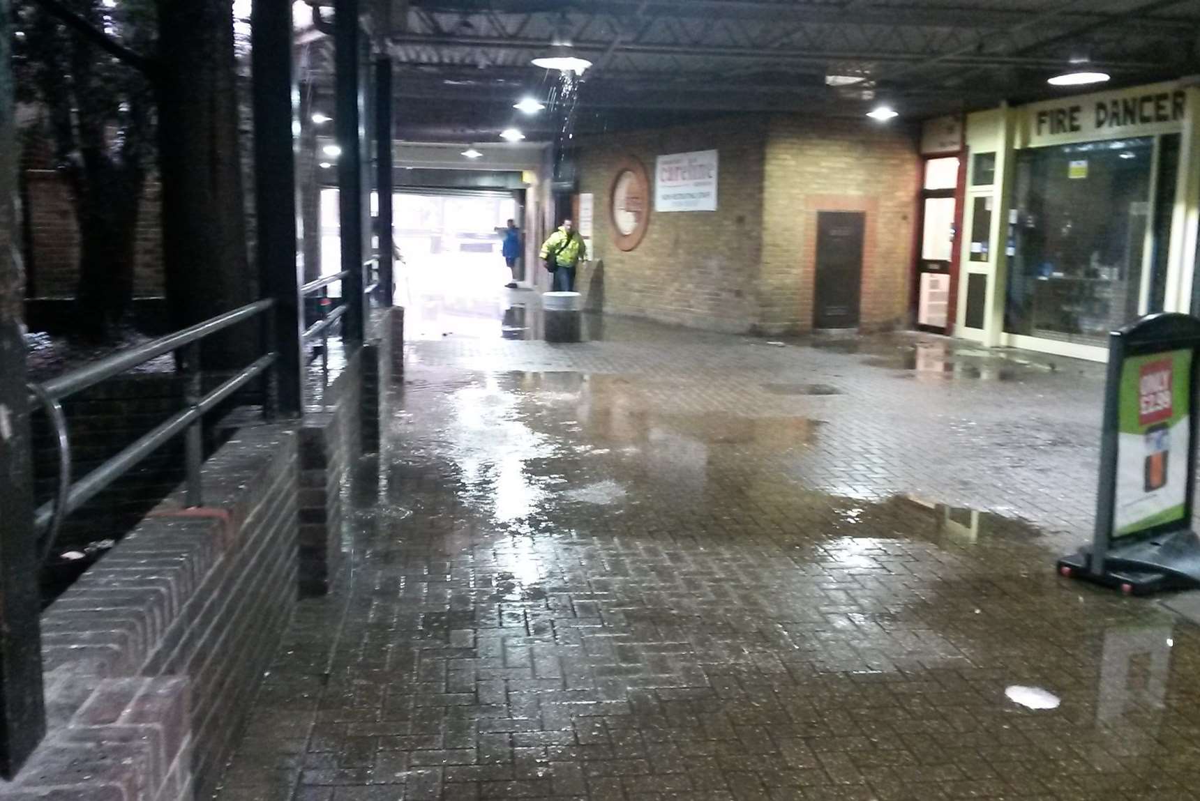 Water pouring through the roof of the building.