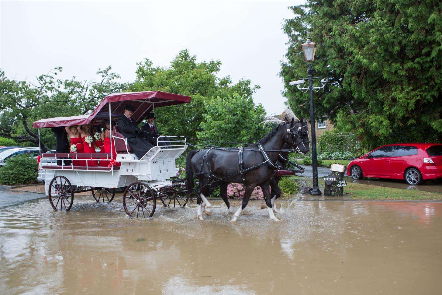 Guests travelling on a second horse-drawn carriage, arrived at the wedding venue with the bottom of their clothes soaked. Picture courtesy of www.bayimages.co.uk