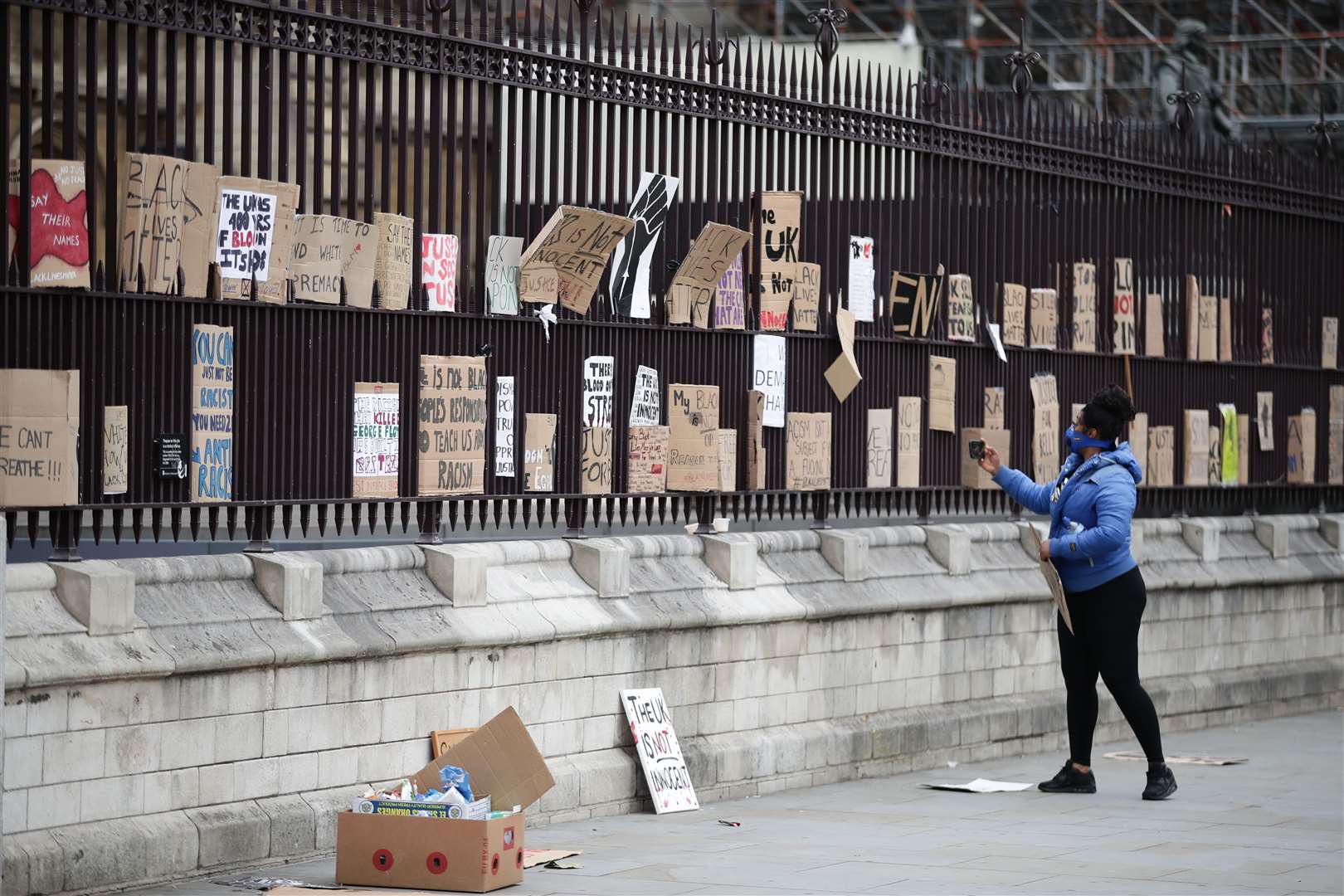 Signs are placed on the fence of the Houses of Parliament (Aaron Chown/PA)