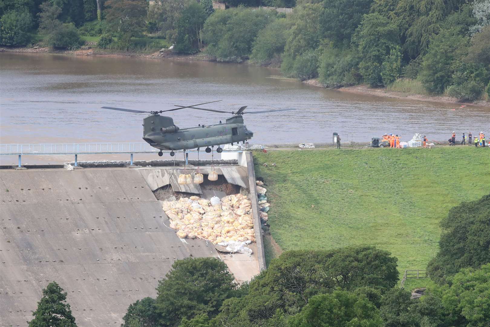 An RAF Chinook helicopter flew in sandbags to shore up the dam (Peter Byrne/PA)