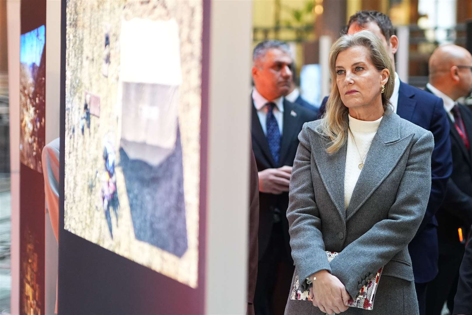 Sophie looks at photographs at the exhibition in the Foreign Office (Aaron Chown/PA)