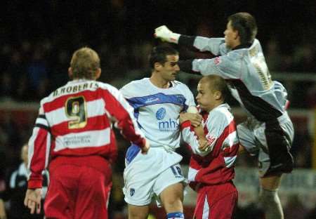 Doncaster keeper Jan Budtz punches clear with Chris Hope lurking. Picture: BARRY GOODWIN