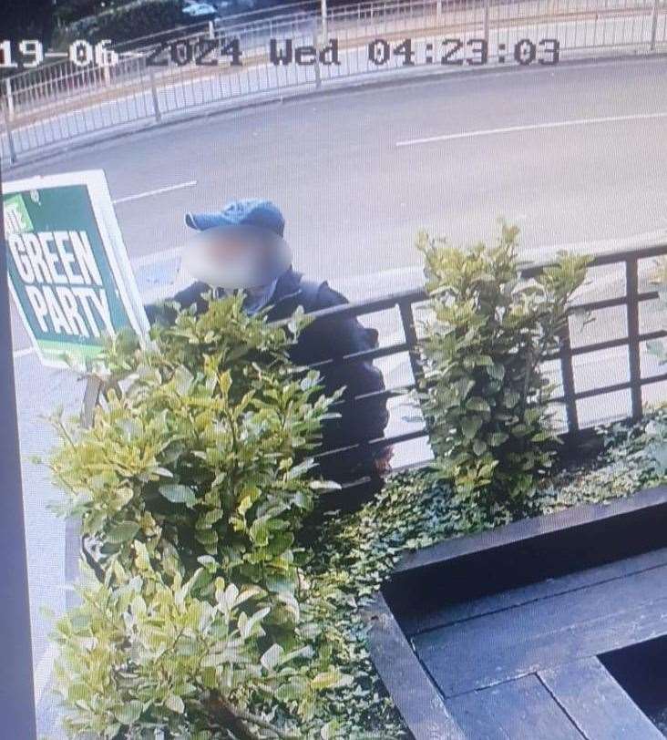 This man was caught on camera defacing a Green poster