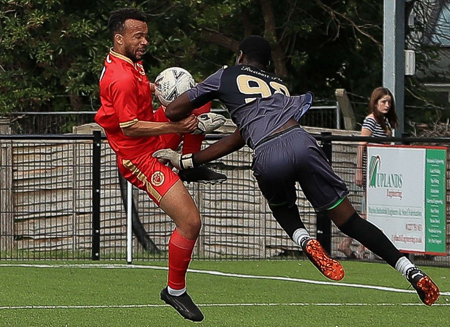 Whitstable’s Karn Miller-Neave tangles with Rusthall keeper Serine Sanneh during the Oystermen’s 3-1 weekend defeat. Picture: Les Biggs