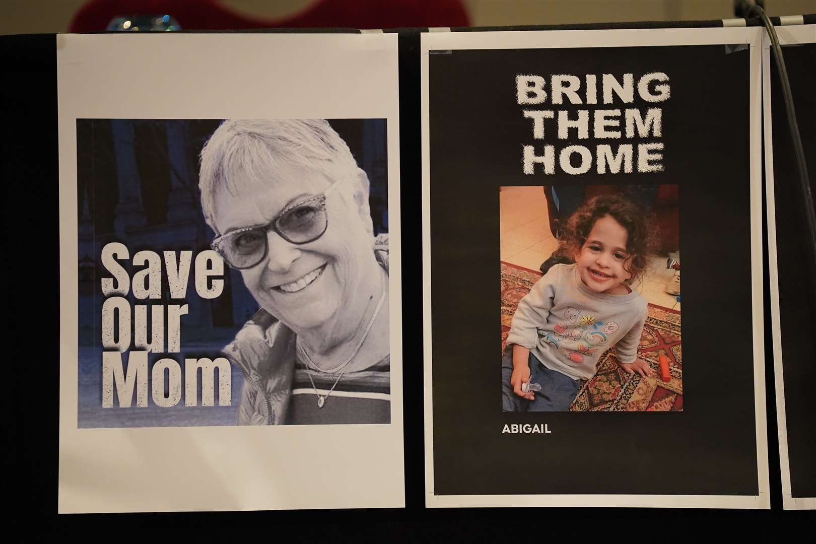 Pictures of loved ones who have been captured by Hamas on display during a Defend Israeli Democracy UK press conference (Lucy North/PA)