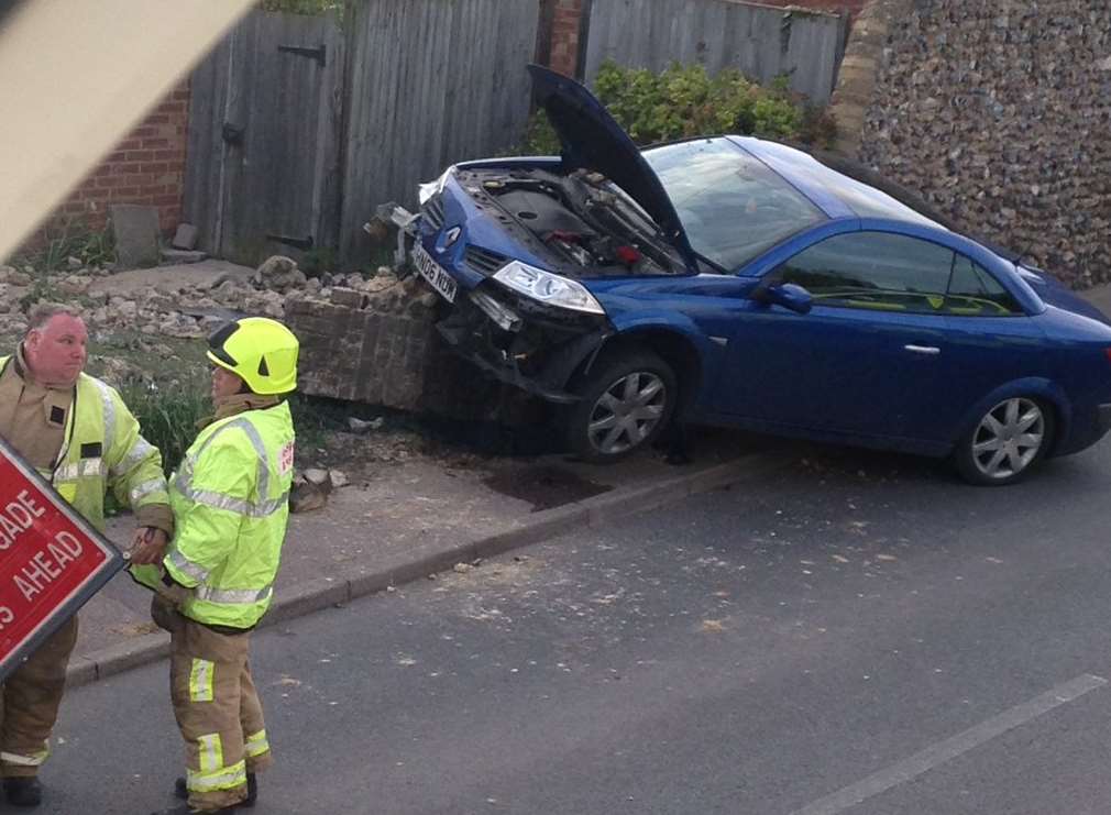 Firefighters set up a sign near the crash site. Picture: Sophie Fleurr