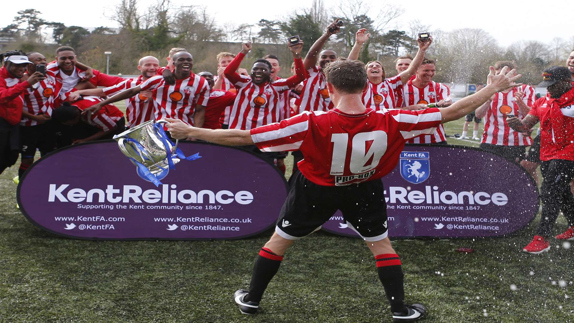 Sheppey United skipper Ian Batten and his squad celebrate their Kent Senior Trophy victory against Ashford United Picture: Andy Jones