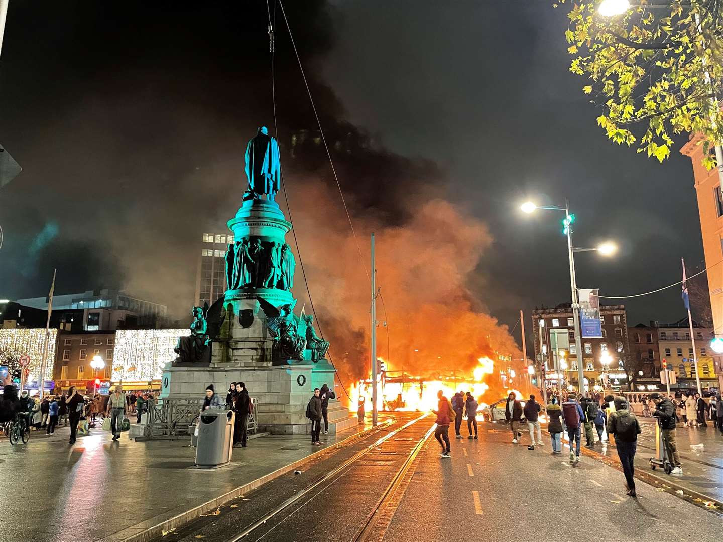 A bus and car on fire on O’Connell Street (Brian Lawless/PA)