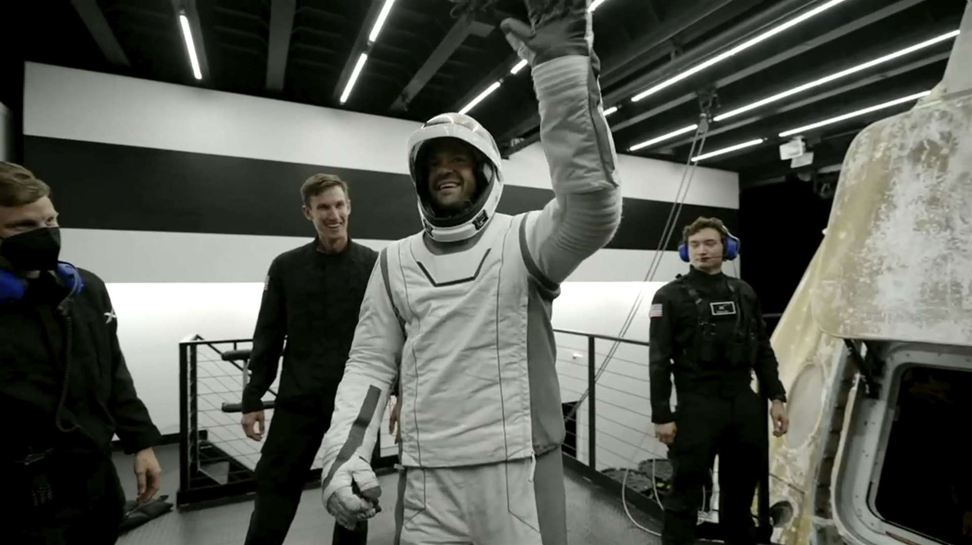 Tech entrepreneur Jared Isaacman, centre, reacts as he gets out of the capsule upon its return to Earth on Sunday (SpaceX via AP)