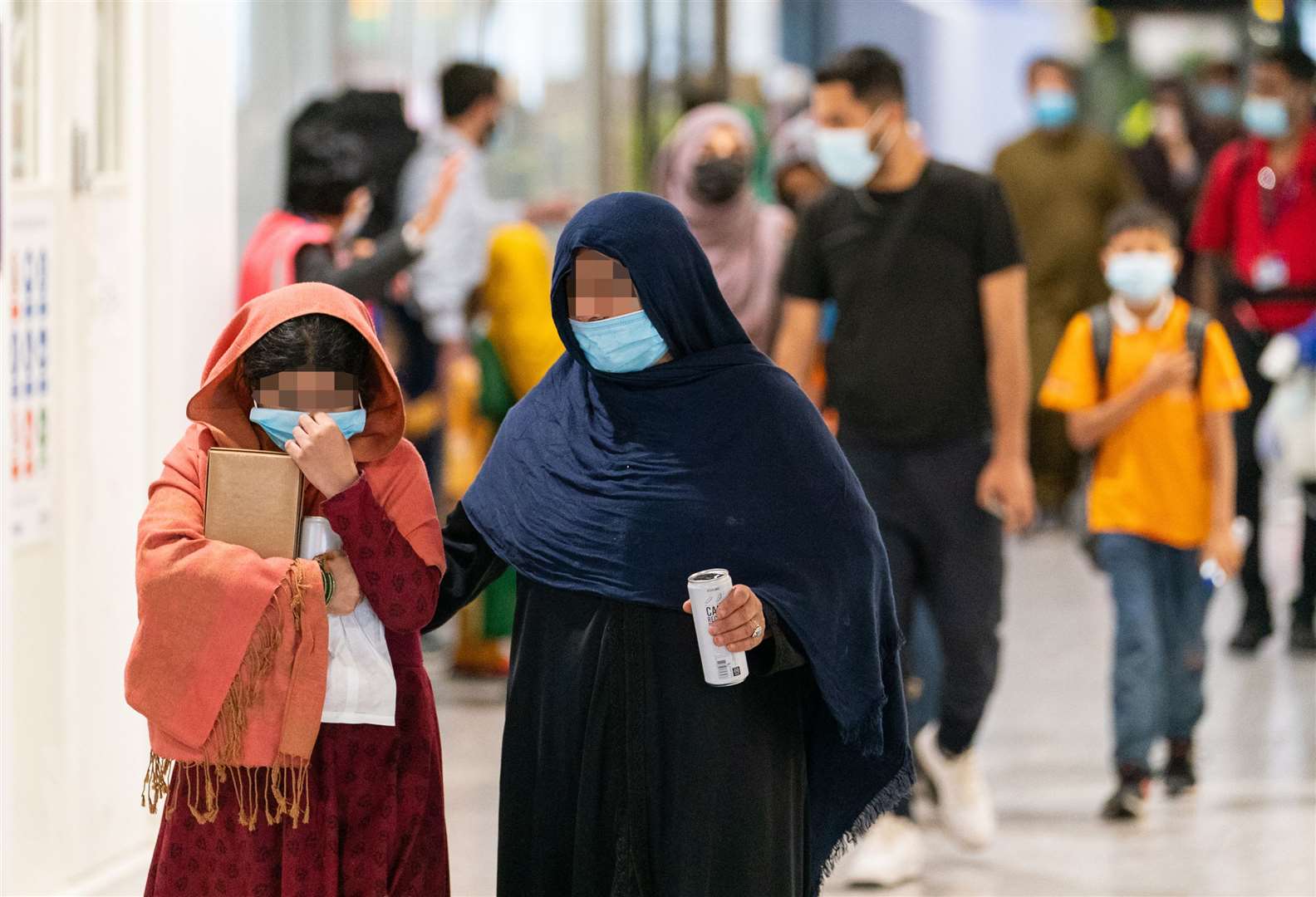 Refugees from Afghanistan arrive on a evacuation flight at Heathrow Airport, London. (Dominic Lipinski/PA)