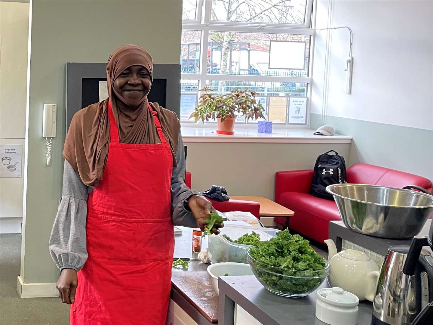 Kaltouma Haroun Ibrahim helping out in the kitchen at Gorbals Parish Church (Church of Scotland/PA)