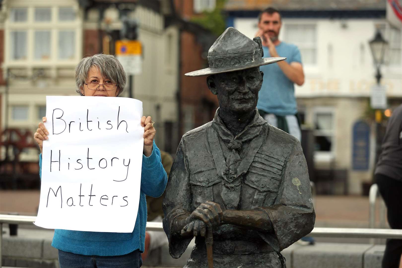 A person with a sign protesting ‘British History Matters’ alongside the statue of Robert Baden-Powell (Andrew Matthews/PA)