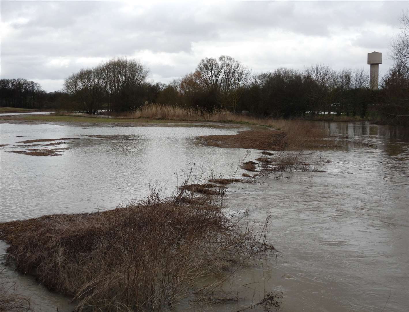 Flooding on the proposed plot earmarked for development off the A2070 is not uncommon. Picture: John Bailey