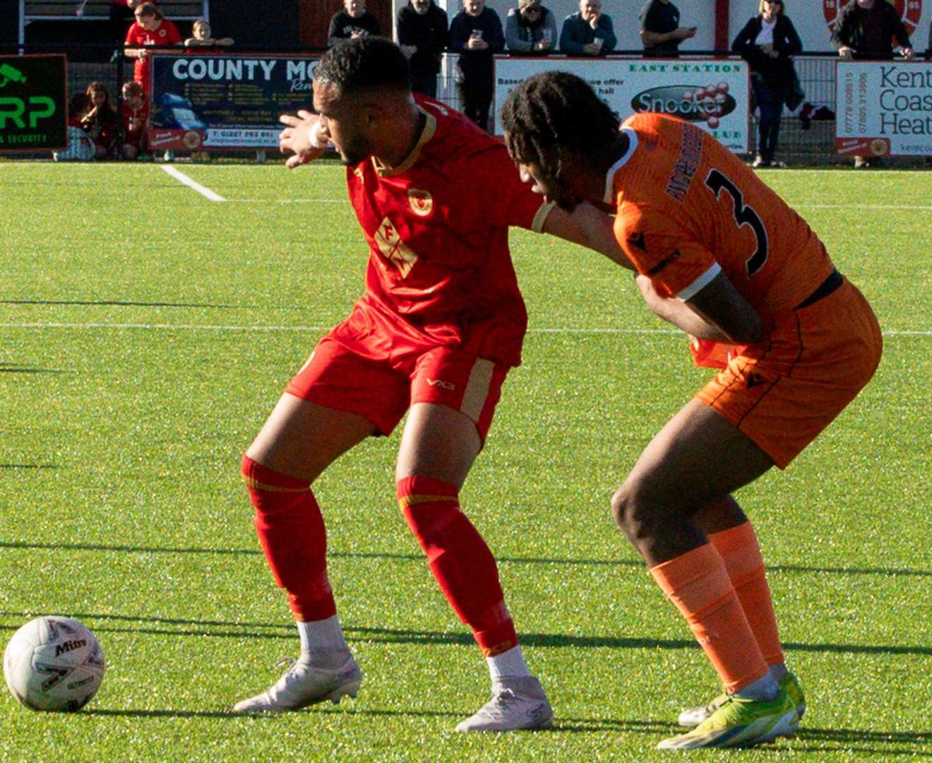 Whitstable scorer Dean Grant holds off Punjab United's Kyden Thomas in last weekend’s 2-1 loss. Picture: Les Biggs