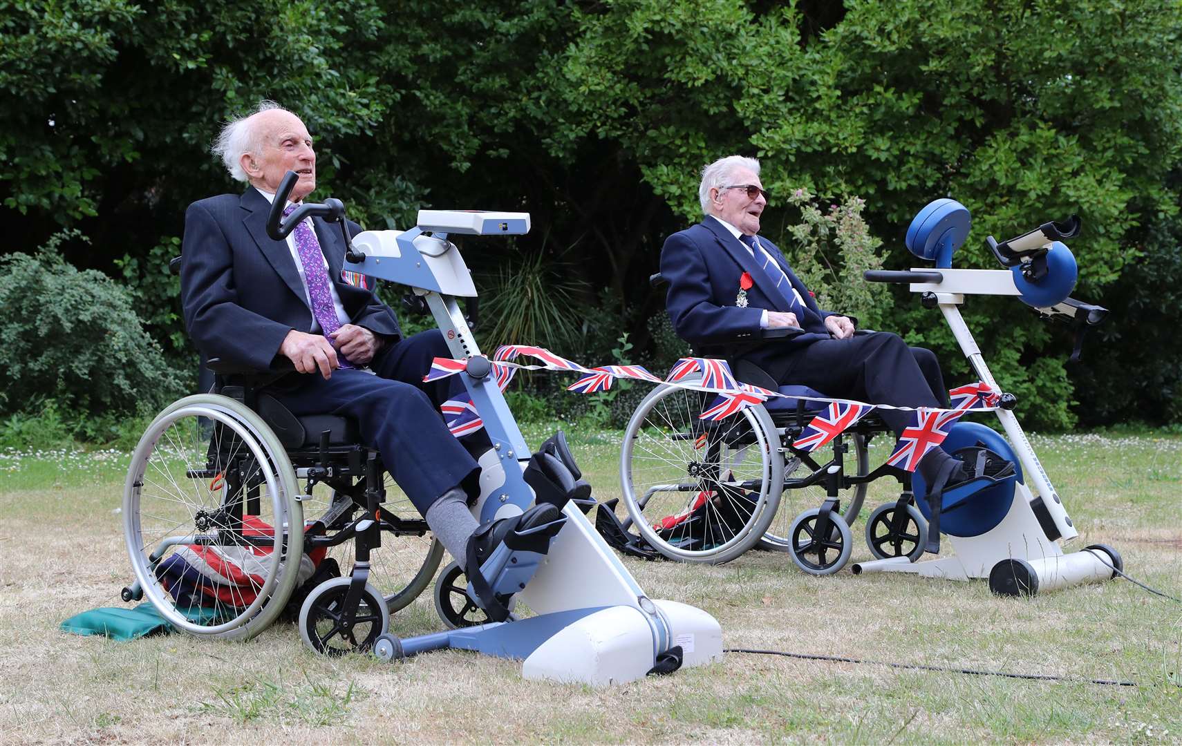 Peter Hawkins and Len Gibbon on their static bikes (Gareth Fuller/PA)