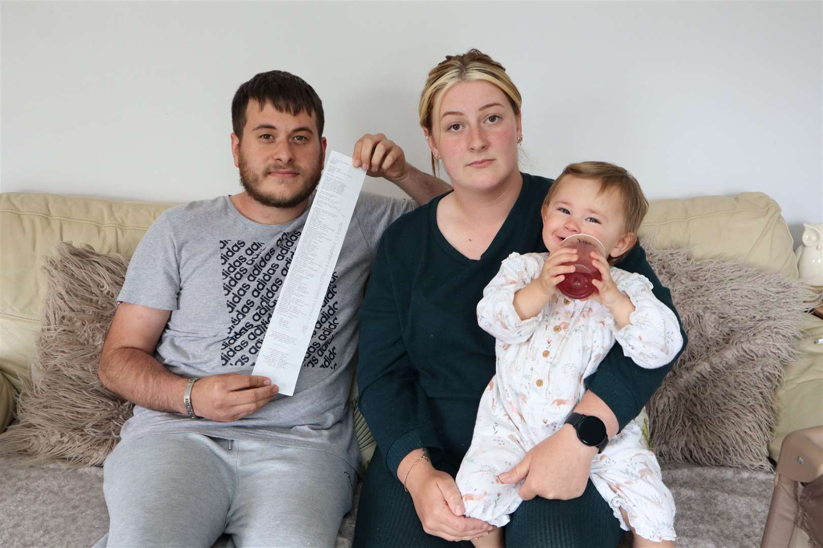 Daniel Joseph, with vet bill, his partner Jazmin Sales and their 18-month-old daughter Ava