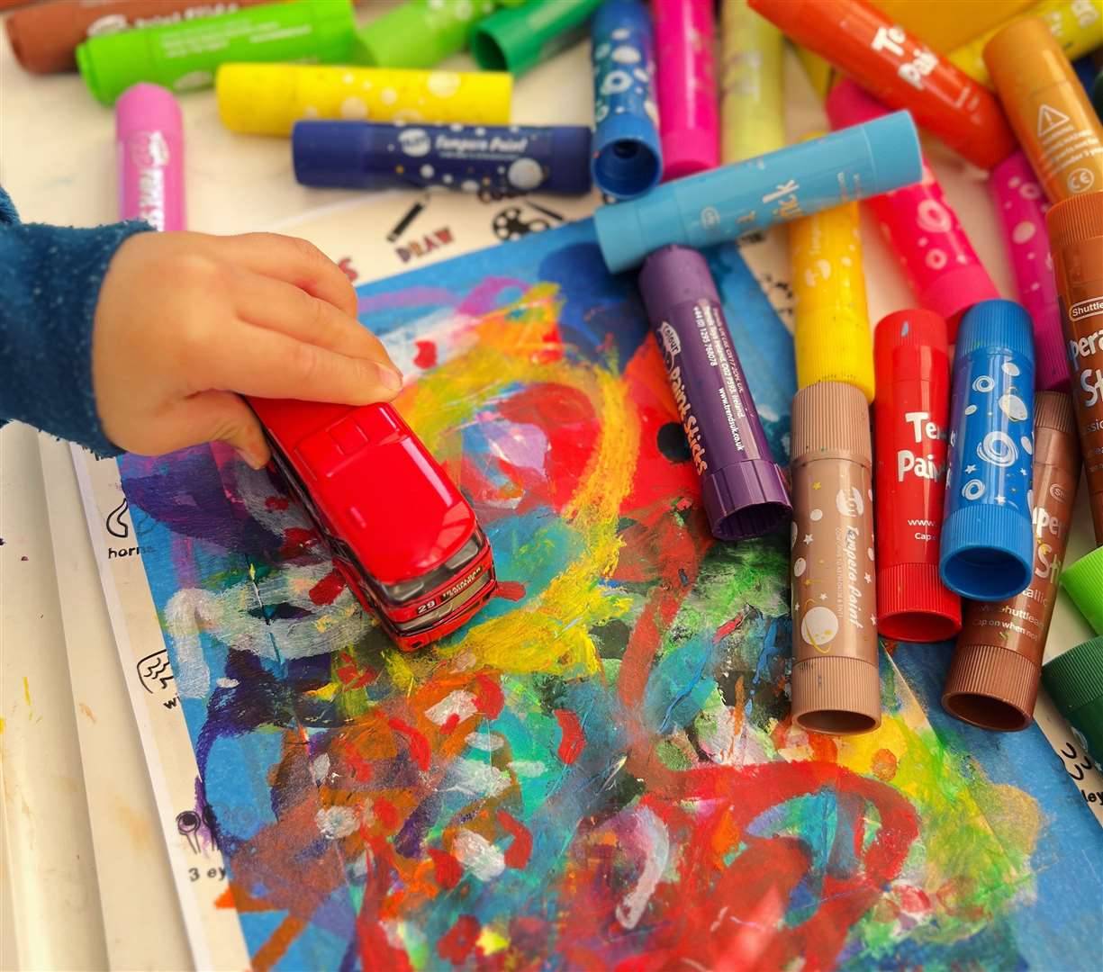 Milo uses paint pens to create his art, along with his favourite red bus. Picture: Mingming Zheng