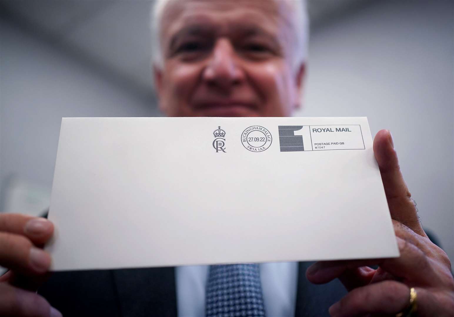 David White with a letter franked with the King’s cypher (Yui Mok/PA)