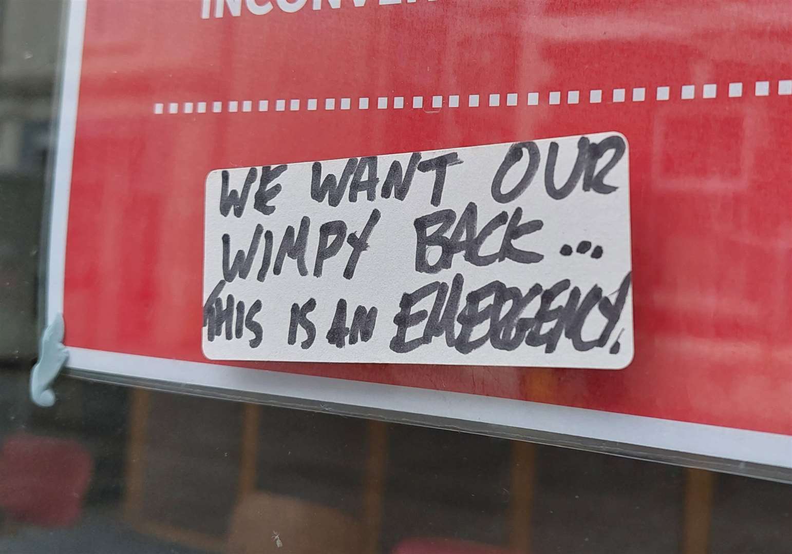 A sticker saying “we want our Wimpy back” has appeared on the window