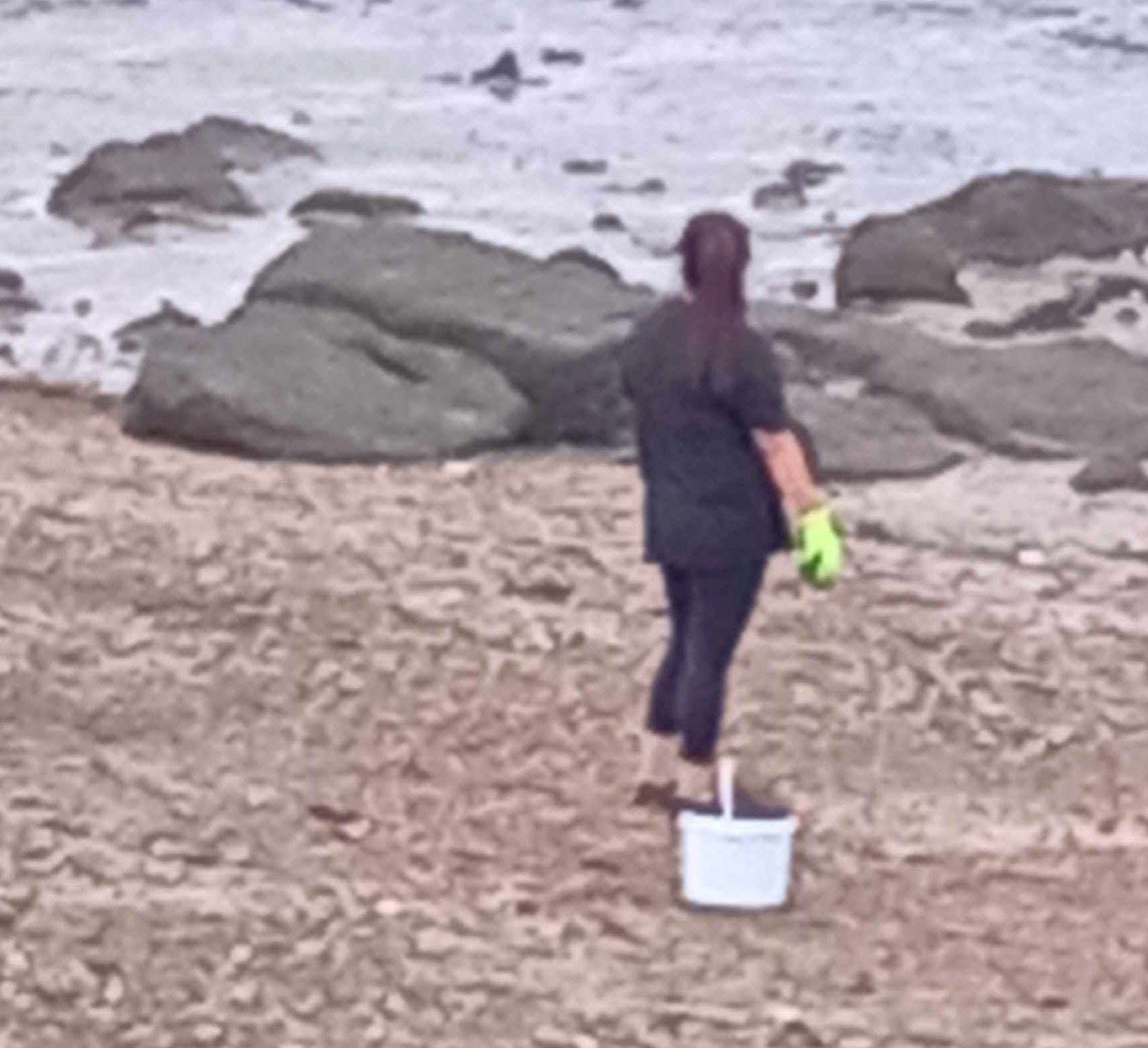 A woman with a bucket at the Shingle Bank. Picture: Mandy Yates