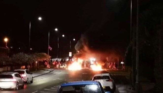 A barricade burns in the middle of North Road in Carrickfergus during another night of loyalist disorder on Monday. (PA)