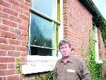 Colin Steer and one of the damaged windows