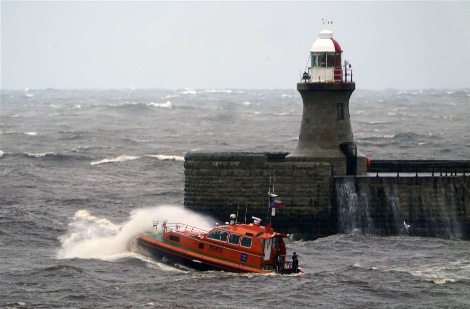 A pilot boat heads out of the Tyne, past South Shields lighthouse, in choppy conditions (Owen Humphreys/PA)