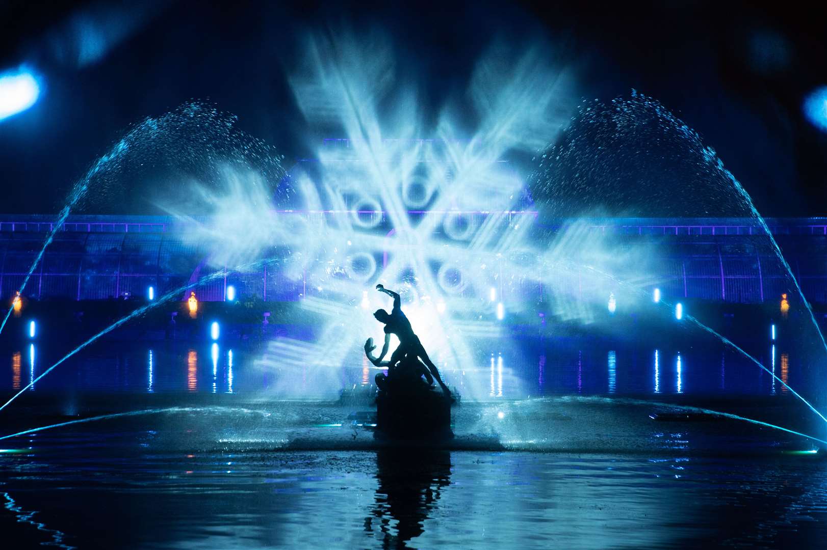 The Palm House Grand Finale includes festive projections falling on a giant screen of water in the lake (Andrew Matthews/PA)