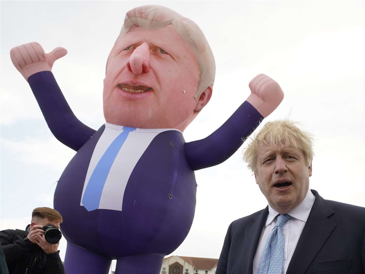 Boris Johnson celebrates the Tories’ victory in Hartlepool alongside a giant inflatable of himself (Owen Humphreys/PA)