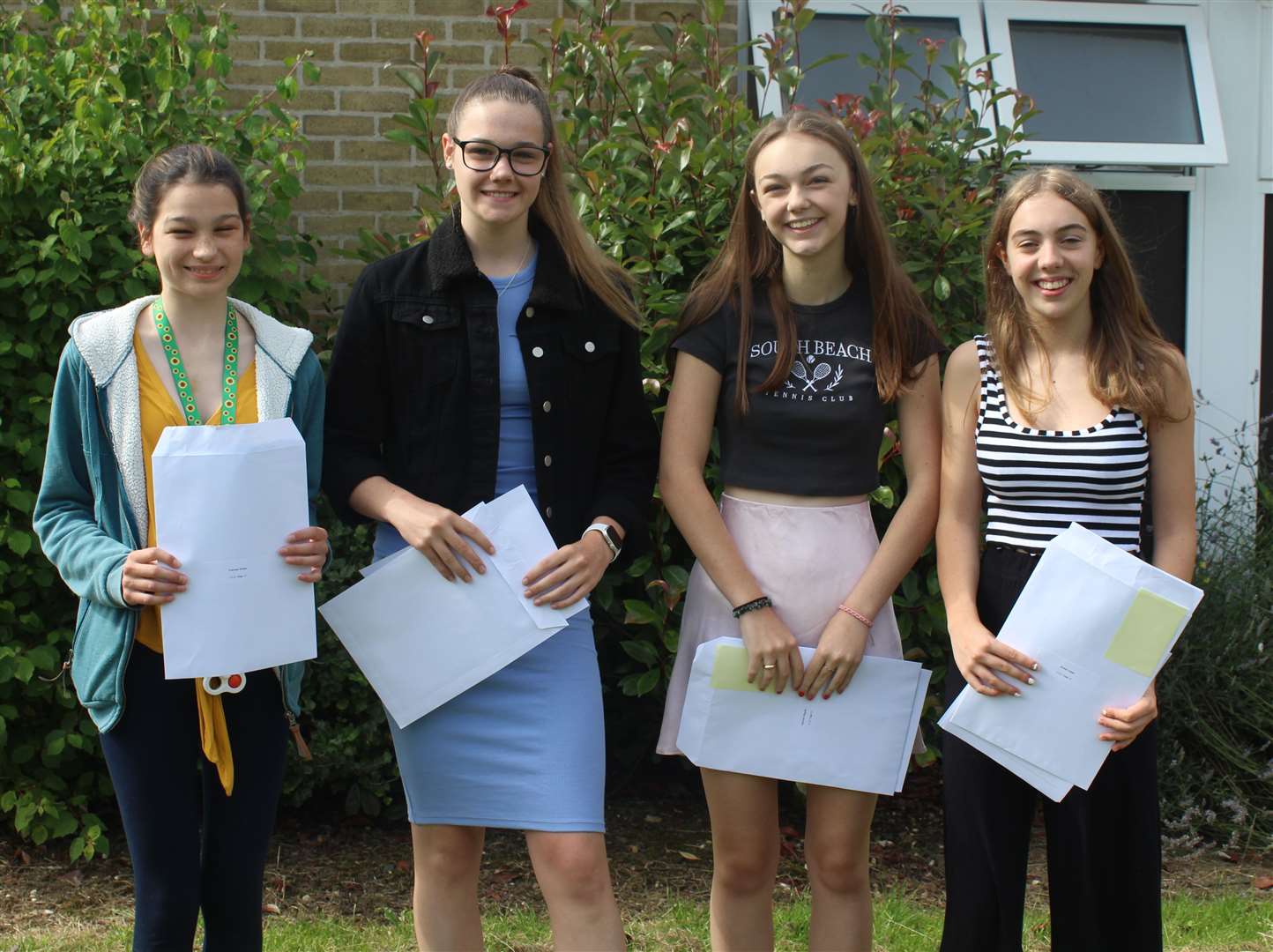 Four pupils at Highsted Grammar School for Girls with their GCSE results at the Sittingbourne school