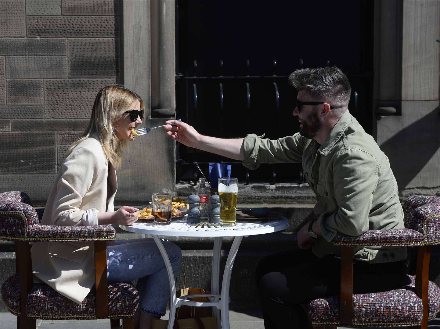 Members of the public enjoy a drink and a meal in Belfast following the reopening of outdoor hospitality (Mark Marlow/PA)