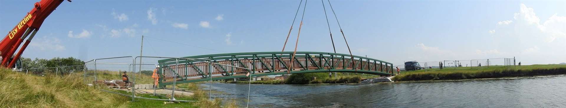 The new £105,000 metal footbridge is gently lowered into position at Barton's Point Coastal Park, Sheerness, Sheppey. Picture: Adam Young of Swale Weather