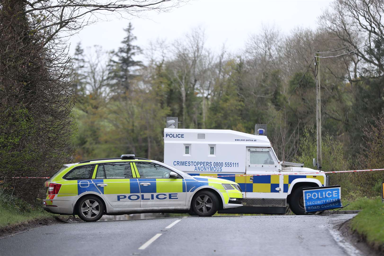 PSNI vehicles block a road near the scene of the incident (Niall Carson/PA)