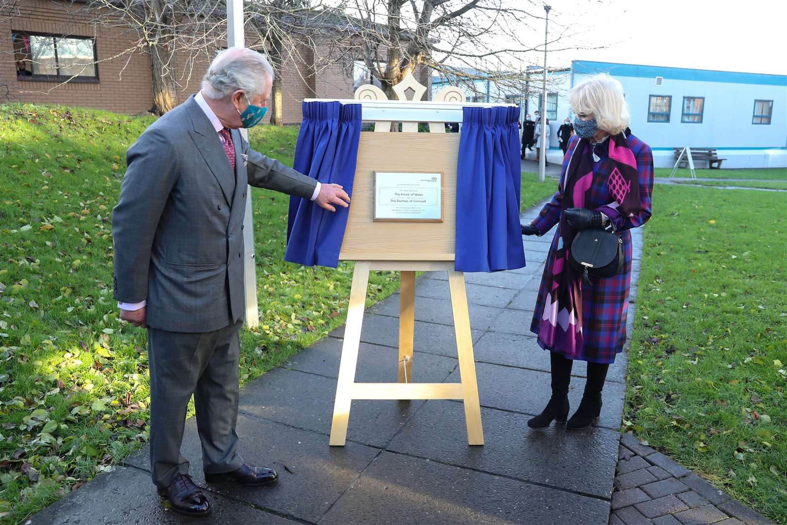 The Prince of Wales and Duchess of Cornwall unveil a plaque to commemorate their visit to Gloucestershire Royal Hospital (Chris Jackson/PA)