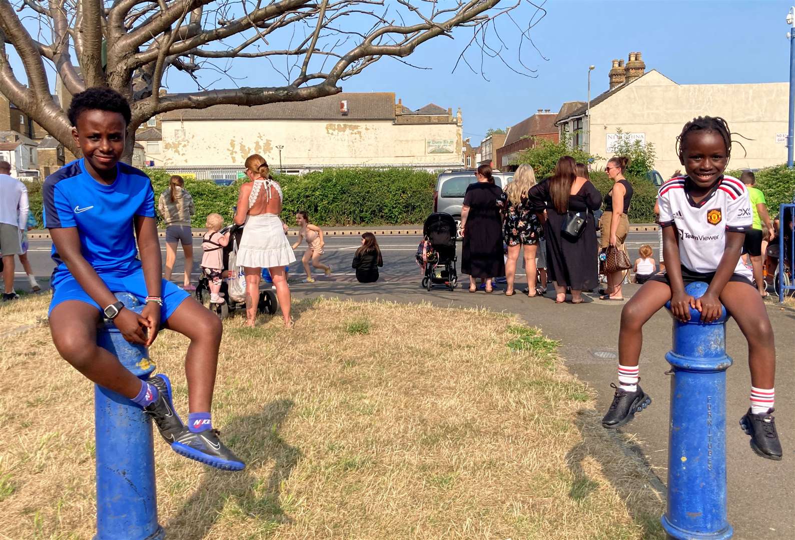 Isaac Njoroge, 10, and his sister Abigail, 6, picked these bollard for a good view of the Sheerness Seaside Festival. Picture: John Nurden