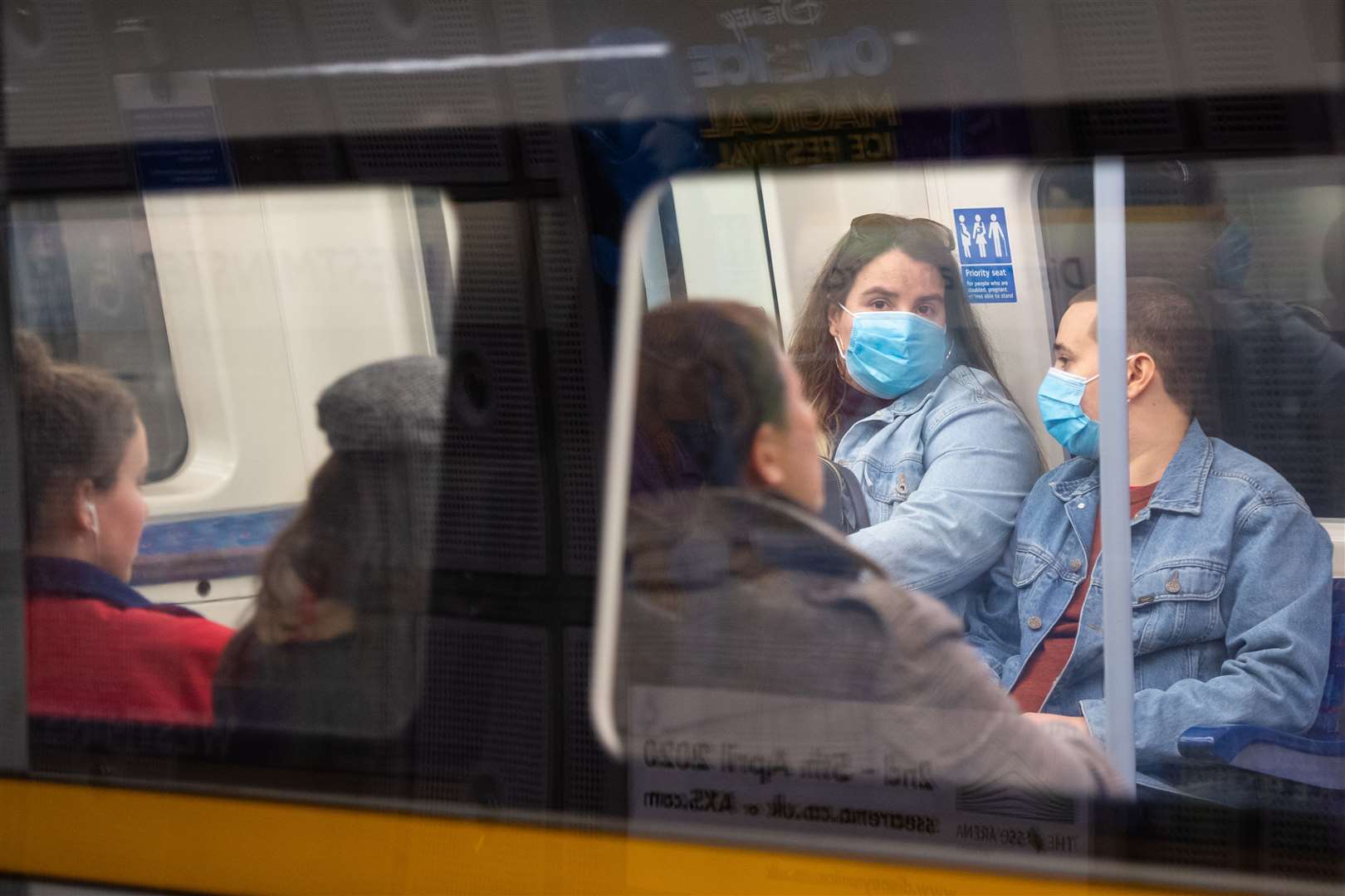 People wear protective face masks on a Tube train (Dominic Lipinski/PA)