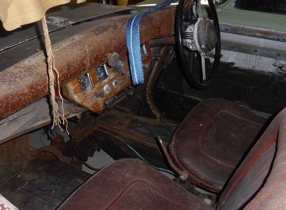 Inside the Murad car showing the wooden dashboard, leather seats and car radio. Picture: Andrew Bone