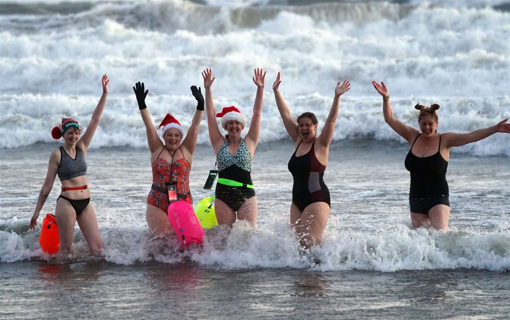 A group of swimmers go for a Christmas day dip at Tynemouth Beach on the North East coast (Owen Humphreys/PA)