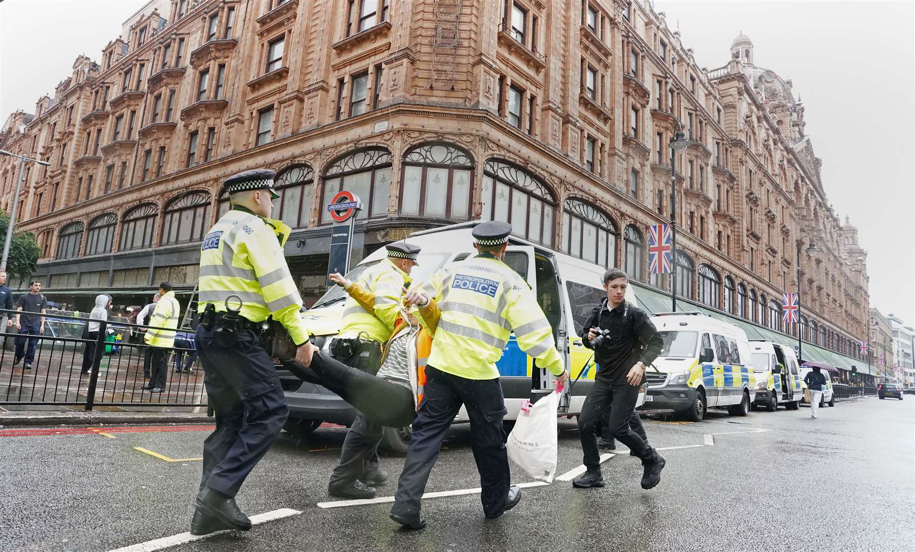 Police officers deal with activists from Just Stop Oil outside Harrods last October (Ian West/PA)