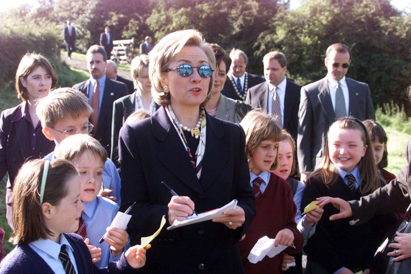 Hillary Clinton, then the first lady, signs autographs for children, during a visit to Lagan Meadows, Belfast (Jeremy Selwyn/PA)