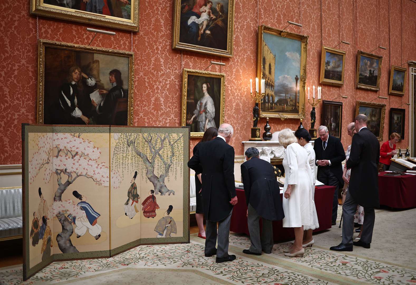 The King and Queen with Emperor Naruhito and his wife Empress Masako view a display of Japanese items from the royal collection at Buckingham Palace (Henry Nicholls/PA)