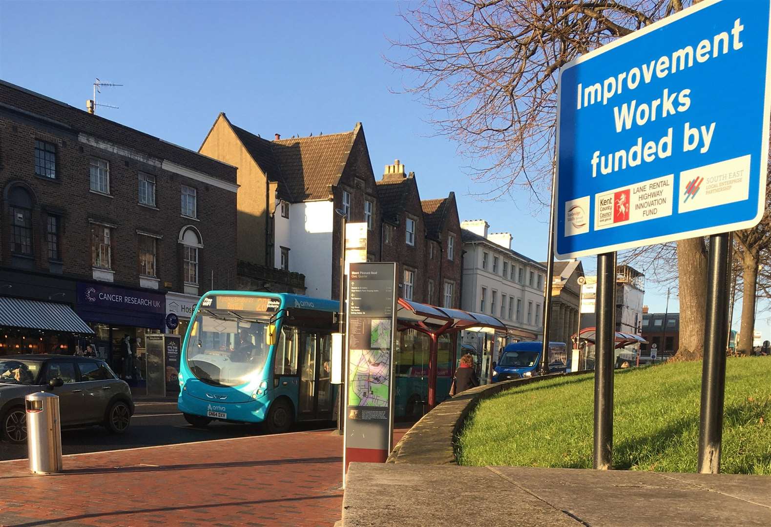 A car and a bus in the bus lane