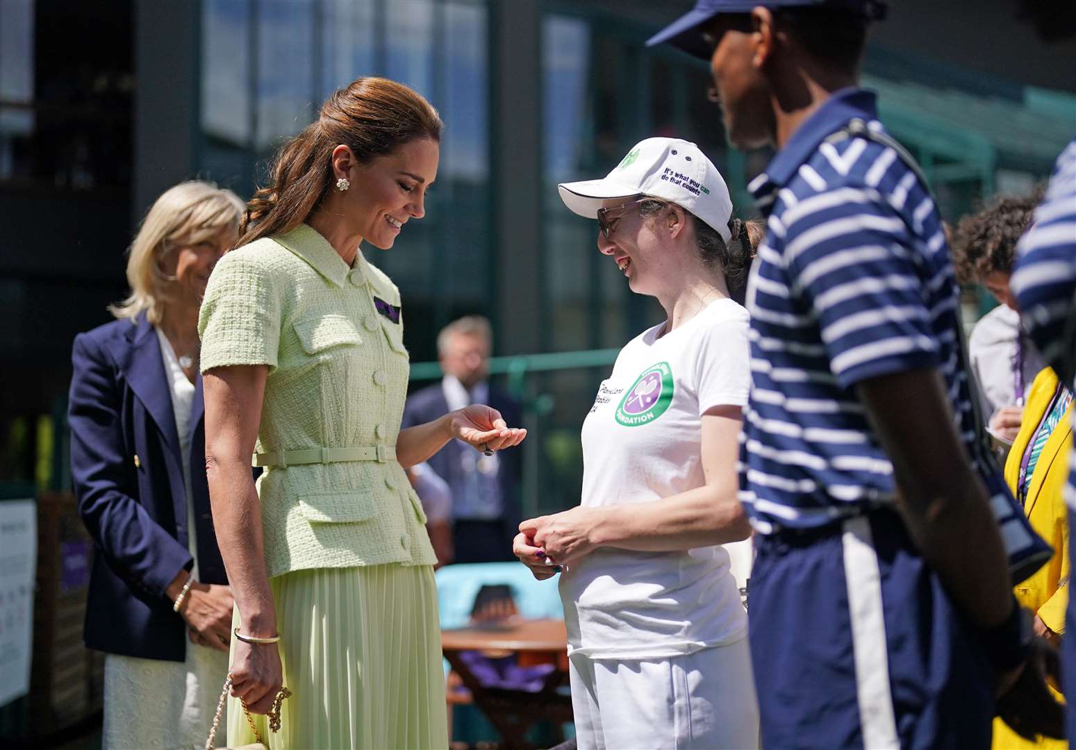 The Princess of Wales looks at the match coin as she speaks to Philippa George (Victoria Jones/PA)